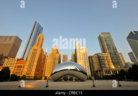 Cloud Gate sculpture, 'The Bean' by Anish Kapoor, in front of the skyline with Legacy at Millennium Park Building, The Heritage Stock Photo