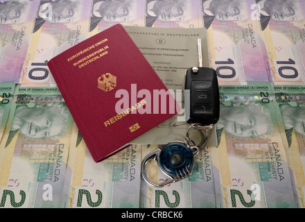 Passport of the Federal Republic of Germany, international driving license, an ignition key and various Canadian dollar Stock Photo