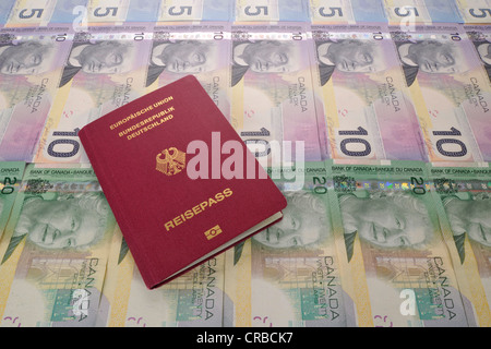 Passport of the Federal Republic of Germany and various Canadian dollar banknotes Stock Photo