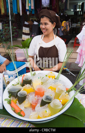 Woman offering fruit juice at the night market in Krabi Town, Krabi, Thailand, Southeast Asia, Asia Stock Photo