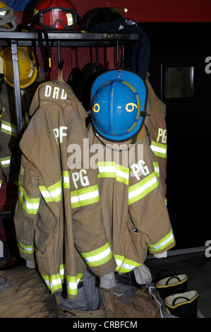 firefighters turnout gear hanging on a wall in a firehouse in Bladensburg, Maryland Stock Photo