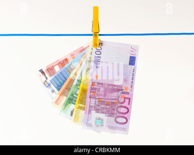 Fan of euro banknotes hanging on a clothesline, symbolic image for money laundering, illegal money Stock Photo
