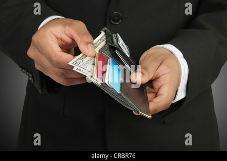 Businessman counting money in wallet Stock Photo