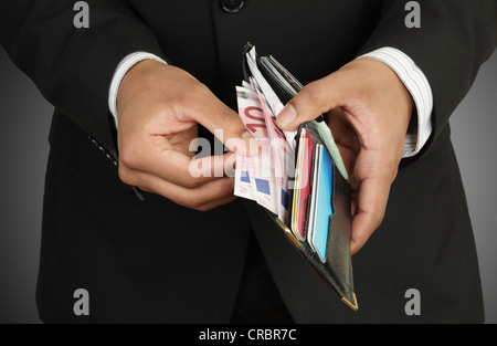 Businessman counting money in wallet Stock Photo