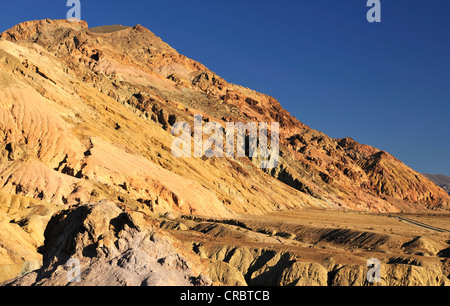 Eroded rocks discoloured by minerals at the Badwater Road in the evening light, Artist's Drive, Death Valley National Park Stock Photo