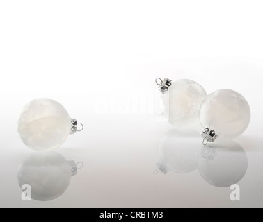 Three white Christmas baubles Stock Photo