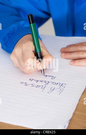 Student practicing handwriting in class Stock Photo