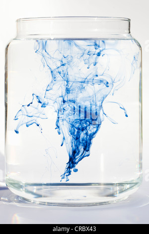 Blue liquid dissolving in water Stock Photo