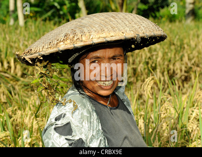 Indonesian woman wearing a traditional straw hat, Ubud, Bali, Indonesia, Southeast Asia Stock Photo