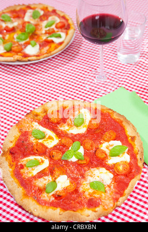 Pizzas on checkered tablecloth Stock Photo