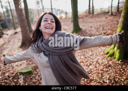 Older woman walking in forest Stock Photo