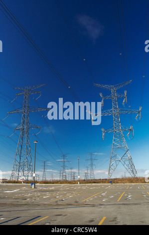 Power lines against blue sky Stock Photo