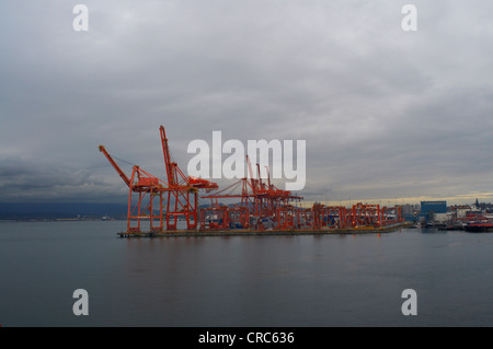 Cranes in shipyard on waterfront Stock Photo