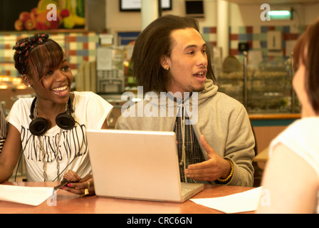 Students using laptop in cafe Stock Photo