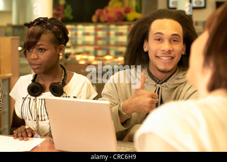 Students working together in cafe Stock Photo