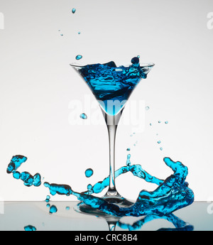 Cocktail splashing around martini glass Stock Photo