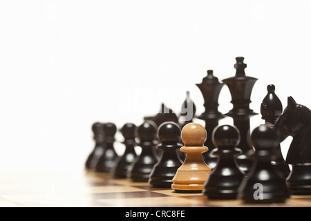 White pawn in black chess set Stock Photo
