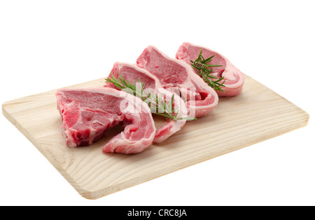 Lamb chops placed on a wooden cutting board - studio shot with a white background Stock Photo