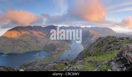Pink clouds at sunrise over Loch Coruisk and the jagged peaks of the Black Cuillin, Isle of Skye, Inner, Hebrides, Scotland Stock Photo