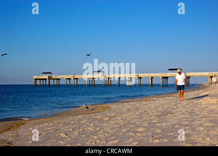 Man walking fine white sand shoreline Orange Beach Gulf Shores Alabama resort tourism area Stock Photo