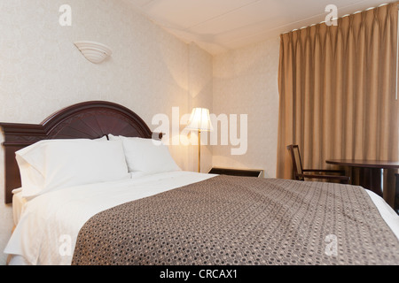 A bed in a hotel room. Stock Photo