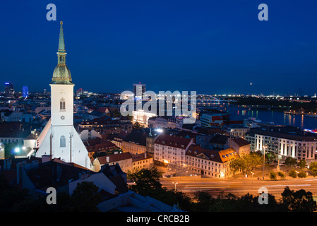 Cityscape of Bratislava at night with St. Martin's Cathedral in front, Slovakia Stock Photo