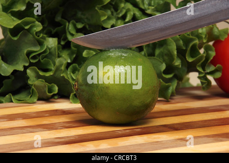 Single Lime on cutting board Stock Photo