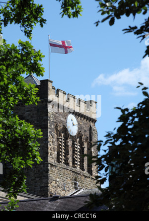 St George's cross flying above the tower of Hexham Abbey Northumberland England UK Stock Photo