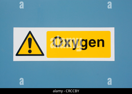 Oxygen yellow warning sign on blue door First aid storage at lifeguard station Llangrannog Ceredigion Mid Wales UK Stock Photo