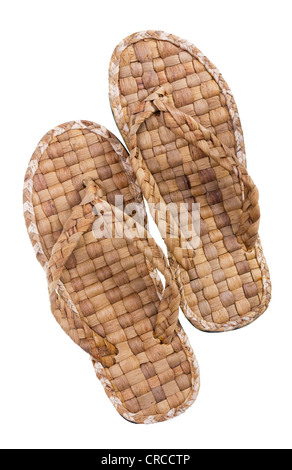 The light summer footwear is weaved from straw and the papyrus on white Stock Photo