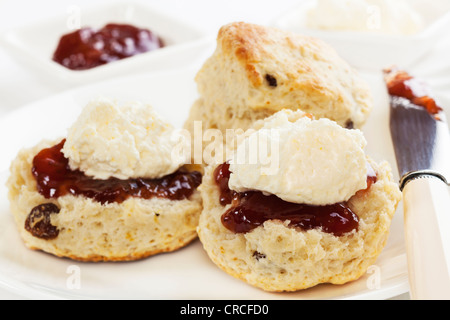 Fresh homemade fruit scones with jam and cream. Stock Photo