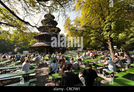 People sitting in a beer garden at the Chinese Tower int he English Garden, Munich, Bavaria, Germany, Europe Stock Photo