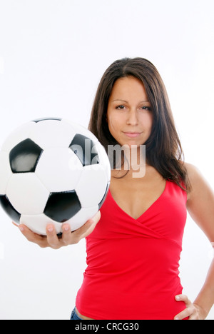 young cute woman in red top with soccer ball Stock Photo