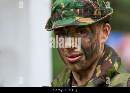 Young Male in army cadet camoflage wearing camoflage make-up. Stock Photo