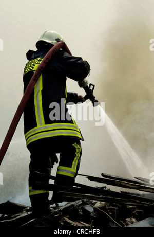 firefighter in full activity, Germany Stock Photo