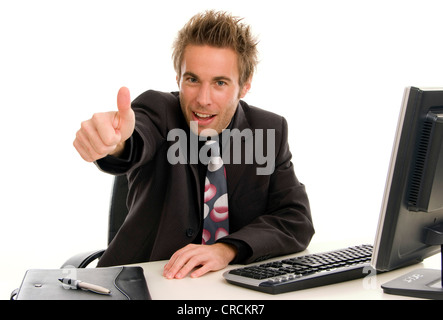 young successful businessman at his desk, making thumb up Stock Photo