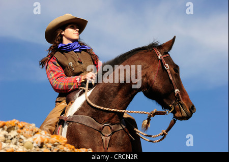 Cowgirl on a horse looking into the distance, Saskatchewan, Canada, North America Stock Photo