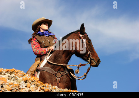 Cowgirl on a horse looking into the distance, Saskatchewan, Canada, North America Stock Photo