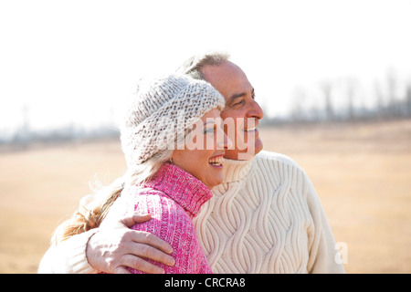 Smiling couple embracing outdoors Stock Photo