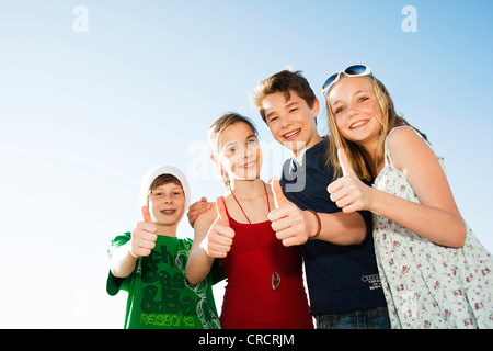 Four happy teenage friends outdoors Stock Photo