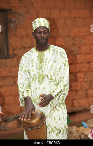 Man wearing traditional dress and playing a traditional musical instrument, Bamenda, Cameroon, Africa Stock Photo