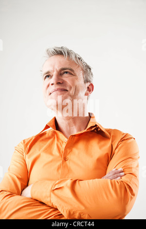 Confident mature man wearing orange shirt Stock Photo