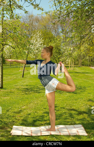 Young woman doing yoga Stock Photo