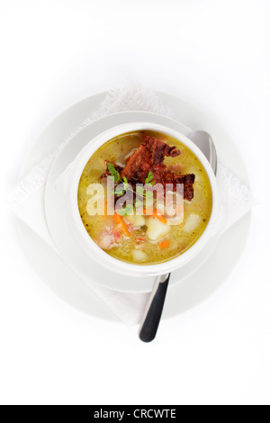 Potato soup with bacon crust served in a terrine Stock Photo