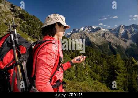 Hiker using GPS, Dolomites, South Tyrol, Italy Stock Photo