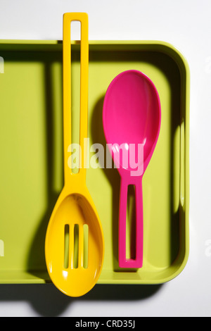 Two plastic spoons on plastic tray Stock Photo
