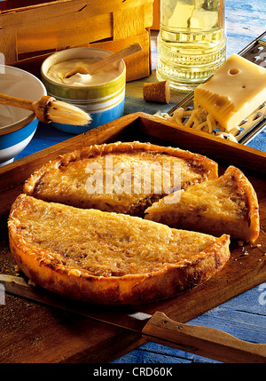 Potato cake with a filling of sauerkraut, bacon, cheese and creme fraiche, Germany. Stock Photo