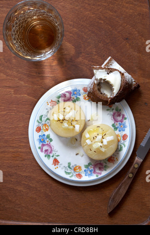 Cider and two marinaded german hand cheese with onions Stock Photo