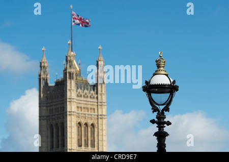 Lamp post on south bank with Victoria tower / Houses of Parliament against a blue in the distance. London, England Stock Photo