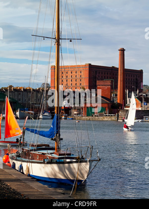 Small sailing boat in Bristol Docks and Harbour area in the city centre England UK which has been extensively redeveloped Stock Photo